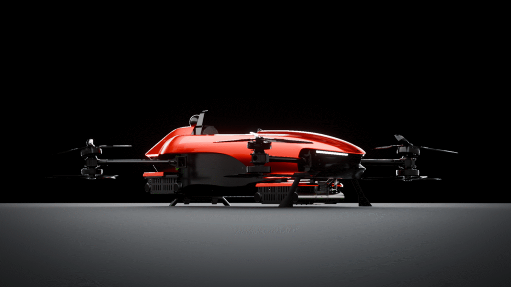 Red sleek quadcopter drone on a gray surface against a dark, black background.